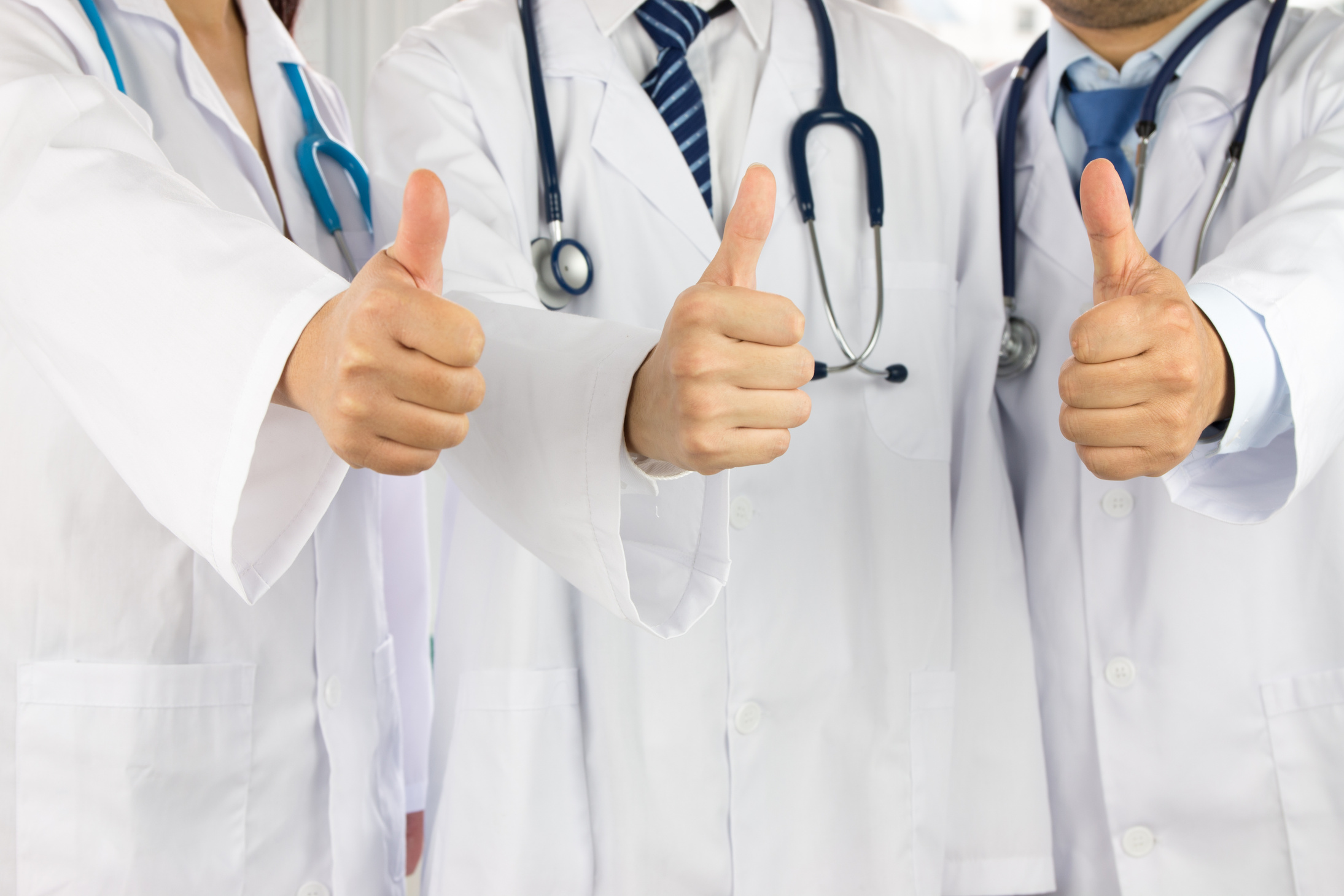 team of doctors and nurses thumbs up